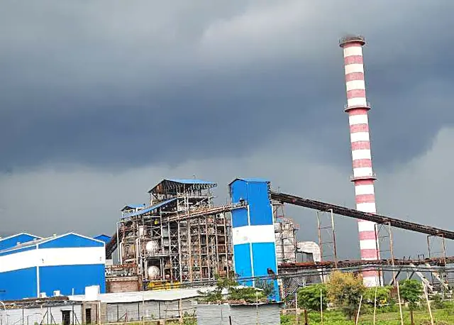 Sugar mill and chimney under a stormy sky