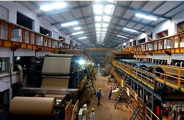 Paper-mill hall with a long paper machine