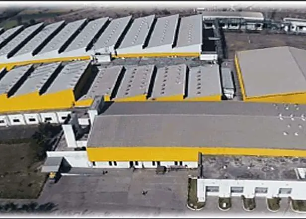 Aerial view of a textile plant with yellow-trimmed sheds