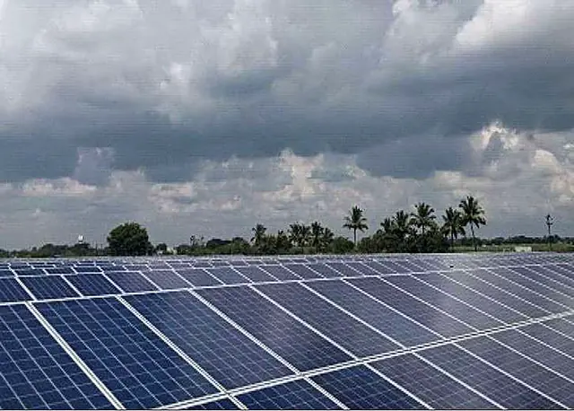 Solar panels under a cloudy sky